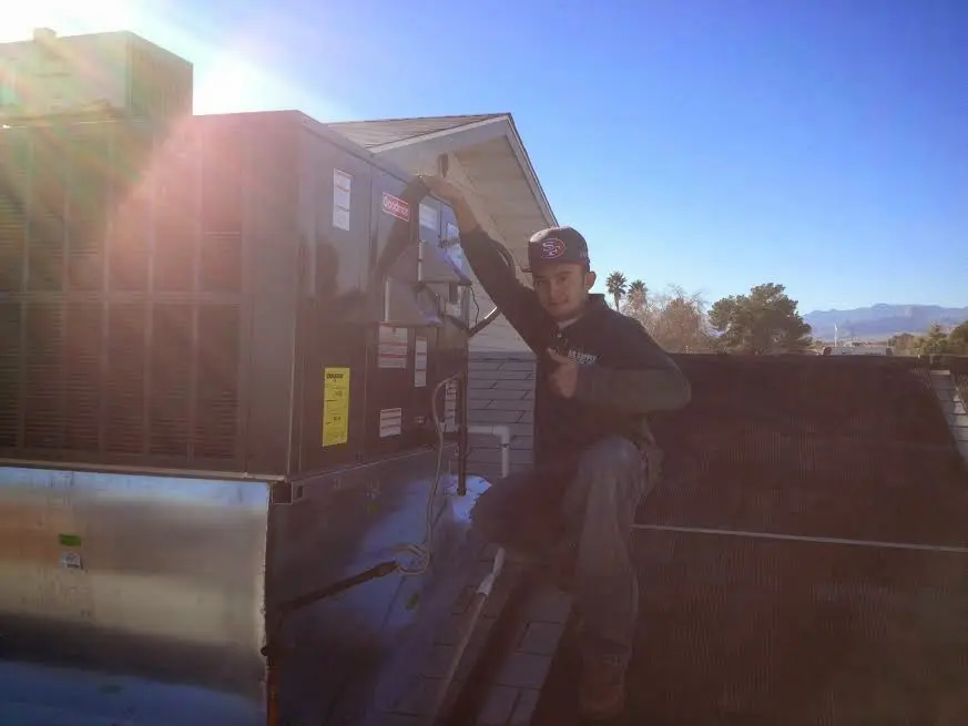 HVAC technician performing HVAC Inspection on a rooftop unit in Gun Plain